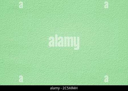 Green stucco texture. Architectural abstract background. Pistachio wall of building. Stock Photo