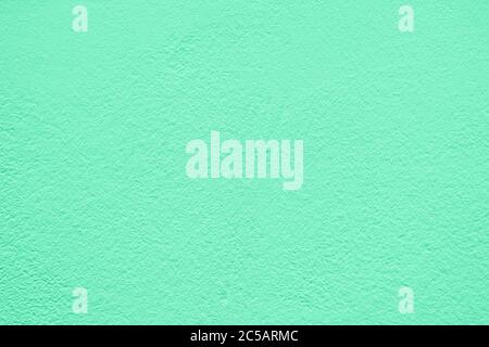 Green stucco texture. Architectural abstract background. Pistachio wall of building. Stock Photo