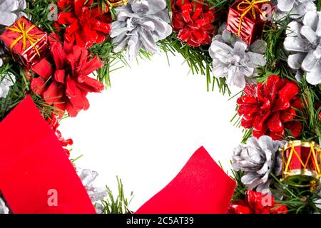 mock up frame for a New Year's card with decorated Christmas red tree cones and artificial green needles. Stock Photo