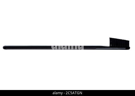 Toothbrush with soft bristles of black color isolated on a white background. Stock Photo