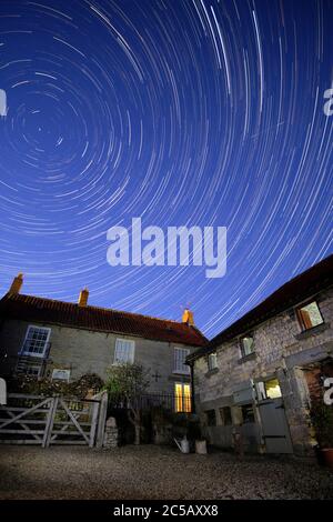 Star Trails over a traditional Yorkshire house. Stock Photo