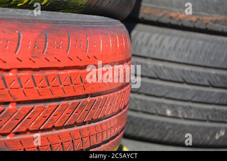 Tires. Red car tires vertically stacked / piled up. Good background for business card for the tire business. Picture for tire business card. Stock Photo