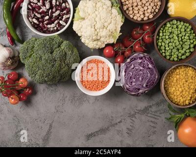 Set of fresh vegetables, fruits and legumes on a gray background. Stock Photo