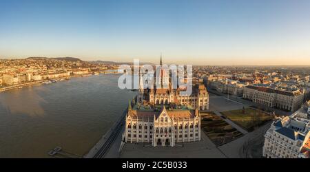Panoramic aerial drone shot of south side facade of Hungarian Parliament during Budapest sunrise Stock Photo