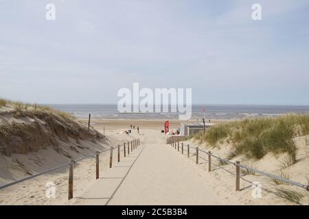 The entrance to the beach at Egmond aan Zee. View of the sea, the North Sea with people in spring. Egmond aan Zee, Netherlands, April 10, 2020. Stock Photo