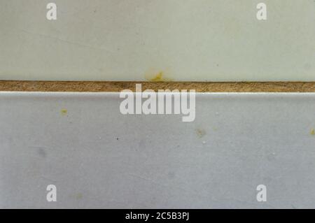 Closeup shot of a white dirty tiles of a wall Stock Photo