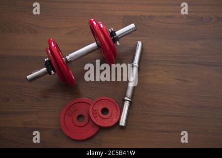 High angle shot of dumbbells on a wooden surface Stock Photo