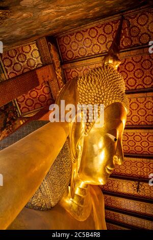 Close-up on the Reclining Buddha - one of the largest Buddha statues in Thailand - located at the Buddhist complex of Wat Pho, Bangkok. Stock Photo