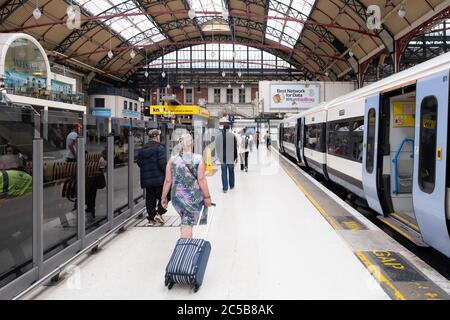 Passengers at the platform and trains at London Victoria Station Stock Photo