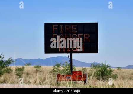 A sign warns of fire danger and a ban on shooting, cooking fires and campfires on the Empire-Cienega Conservation Area in the grasslands north of Sono Stock Photo