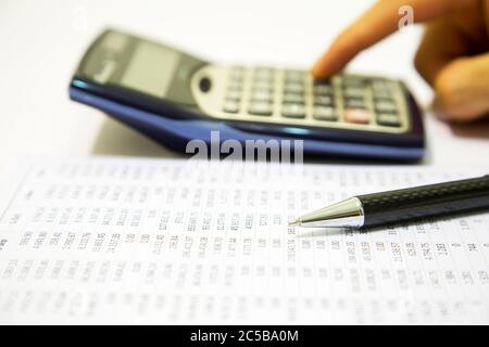 Businessman calculating expense at desk in office Stock Photo