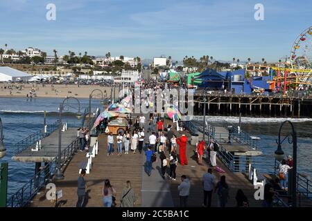 Santa Monica, CA/USA - April 11, 2019: Crowds of people enjoying the Santa Monica Pier on a beautiful day Stock Photo