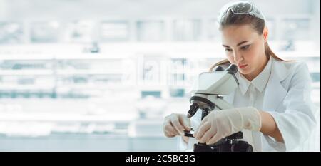Medical Scientist Researcher Using Microscope in Laboratory,  Medicine Specialist Studying and Experiment Anti Virus Pharmaceutical With Microscopic. Stock Photo