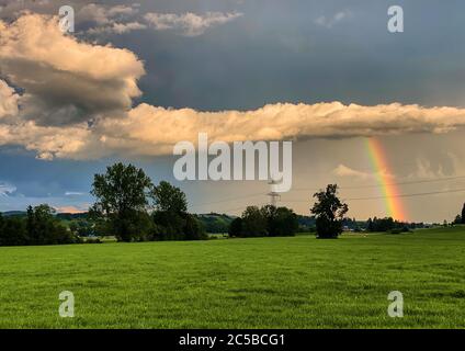 Bertoldshofen, Germany, July 01, 2020.  Stormy weather with heavy rain changes with sunset and rainbow. © Peter Schatz / Alamy Stock Photos Stock Photo