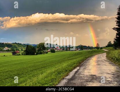 Bertoldshofen, Germany, July 01, 2020.  Stormy weather with heavy rain changes with sunset and rainbow. © Peter Schatz / Alamy Stock Photos Stock Photo