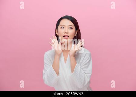 Happy beautiful girl holding her cheeks with a laugh looking to the side Stock Photo