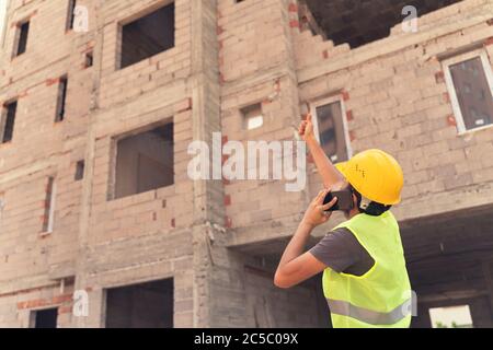Project manager showing thumbs up sign at construction site Stock Photo