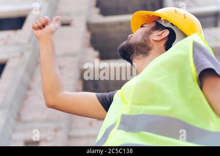 Project manager showing thumbs up sign at construction site Stock Photo