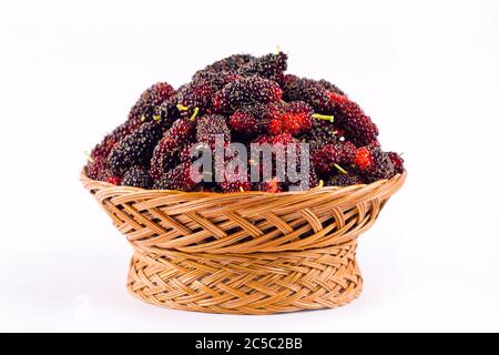 sweet mulberries in  brown basket on white background healthy mulberry fruit food isolated Stock Photo