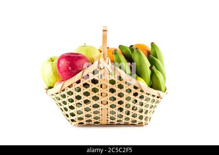 orange, green guava, banana and red apple in bamboo wicker basket on white background fruit health food isolated Stock Photo