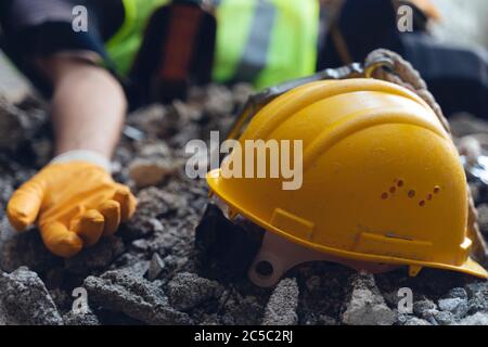 Construction worker has an accident while working on new house. Construction worker lies on the floor at the work site. Work accident Stock Photo