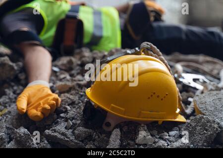 Construction worker has an accident while working on new house. Construction worker lies on the floor at the work site. Work accident Stock Photo