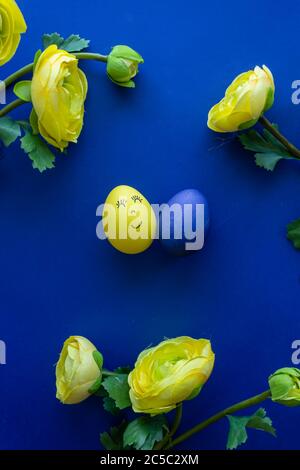 Happy Easter Day Around Yellow Flowers With Blue Egg On a Blue Background  Stock Photo