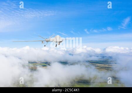 An unmanned vehicle flies over the clouds control and tracking the sky over the territory Stock Photo