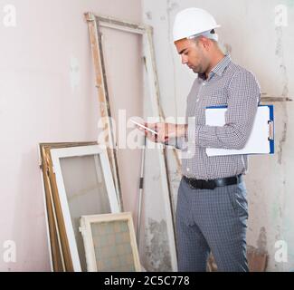 Man engineer with telephone in hand in room Stock Photo
