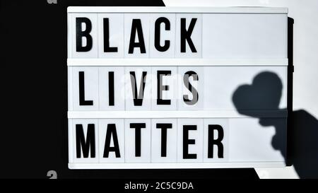 BLACK LIVES MATTER text with deep shadows of heart on a black and white background. Protest against the end of racism, anti-racism, equality Stock Photo