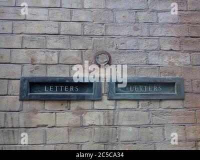 Letter boxes in a brick wall Stock Photo