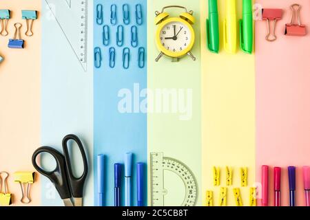 School Supplies In Frame With Colorful Paper Background. School or office stationery on colorful background. Back to School. Copy space. Stock Photo