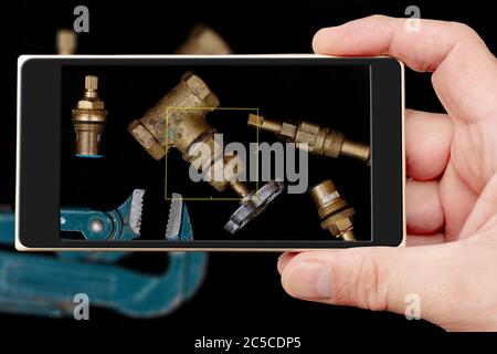 Plumbing tools on black background. Faucets, valve, pipe wrench to repair water supply system. Stock Photo