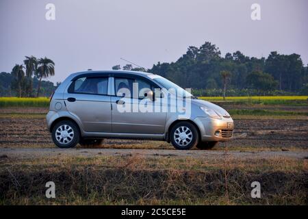 Close up od side view of a Spark, Chevrolet car standing on an empty village road, selective focusing Stock Photo