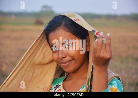 An Indian teenage girl of West Bengal in the fields. Stock Photo