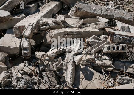 Recycling concrete and construction waste from demolition. Excavator at ...