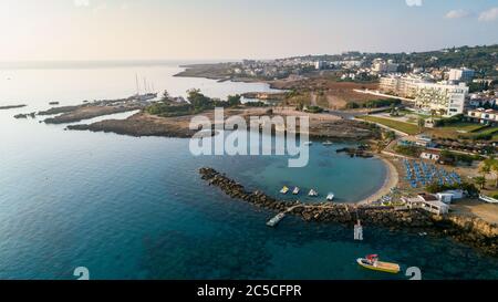 Aerial bird's eye view of Green bay in Protaras, Paralimni, Famagusta, Cyprus. The famous tourist attraction diving location rocky beach with boats, s Stock Photo