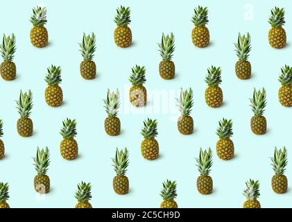 Pattern with pineapples isolated on blue background. Creative tropical fruit concept. Stock Photo