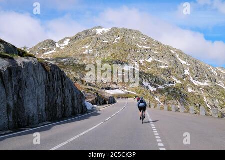 Racing cyclist on the Grimsel Pass in the Swiss Alps, which connects the Bernese Oberland with the Upper Valais, Switzerland Stock Photo