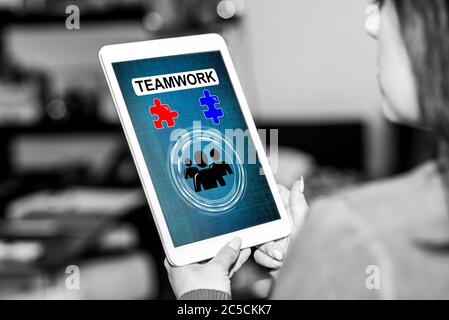 Tablet screen displaying a teamwork concept Stock Photo