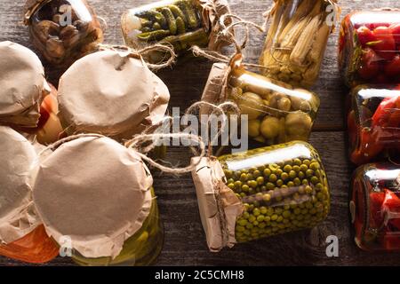 homemade delicious pickles in jars on wooden table Stock Photo