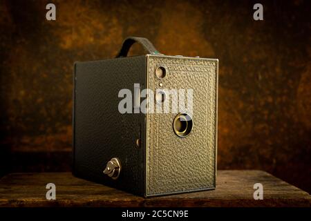 Old camera on a brown background Stock Photo