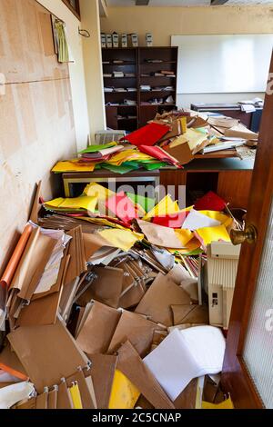 office full of papers and folders due to crisis Stock Photo