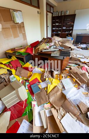 office full of papers and folders due to crisis Stock Photo