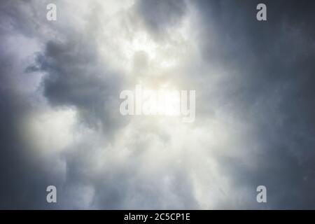 sun breaks through the dark grey clouds the weather inspiration Stock Photo