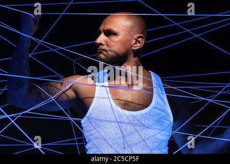 Picture of bald man tangled in white threads Stock Photo