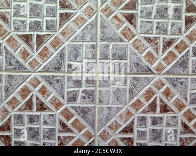 Closeup of dark brown and grey ceramic tiles on wall in village in Andalusia Stock Photo