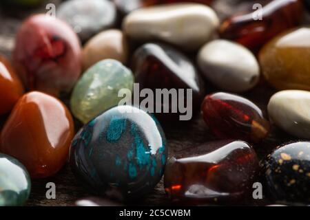Close up view of colorful fortune telling stones on wooden background Stock Photo