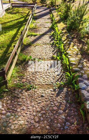 path lined with rocks pavers in back yard garden Stock Photo