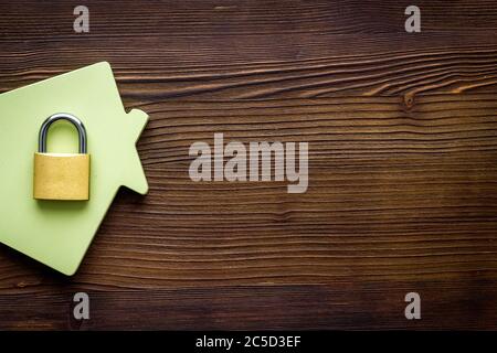 Security concept - lock and house figure - on wooden desk top-down space of text Stock Photo